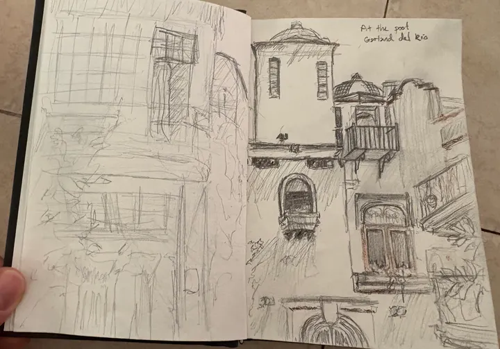 Open sketchbook spread of pencil studies: a window grid on the left, a bell tower and balconies on the right