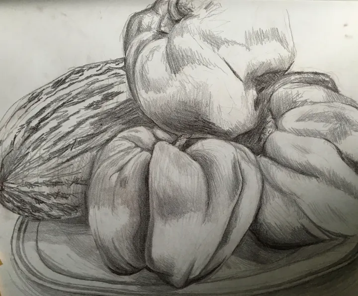 Charcoal still life of peppers and a melon on a plate