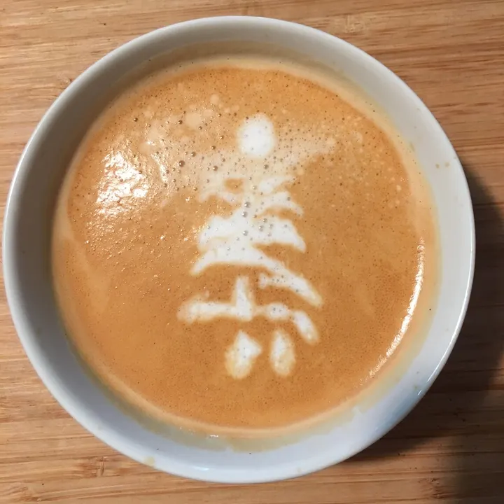 A small, stiff tree-like pattern in a white cup