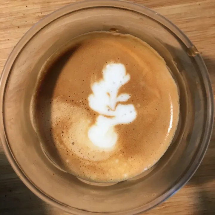 A curly white shape in a glass cup, a little like a seahorse