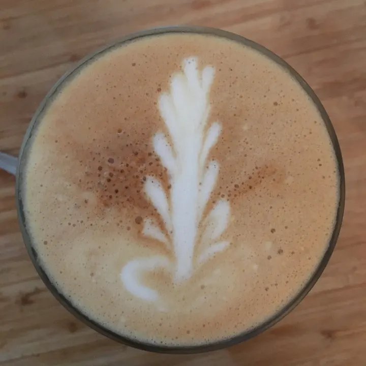 A crisp, symmetrical rosetta in a wide ceramic cup