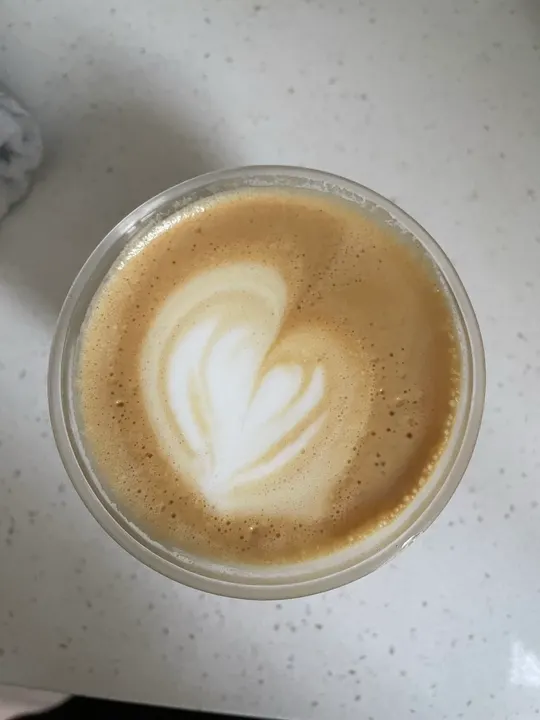 A layered heart in a small glass on a speckled white counter