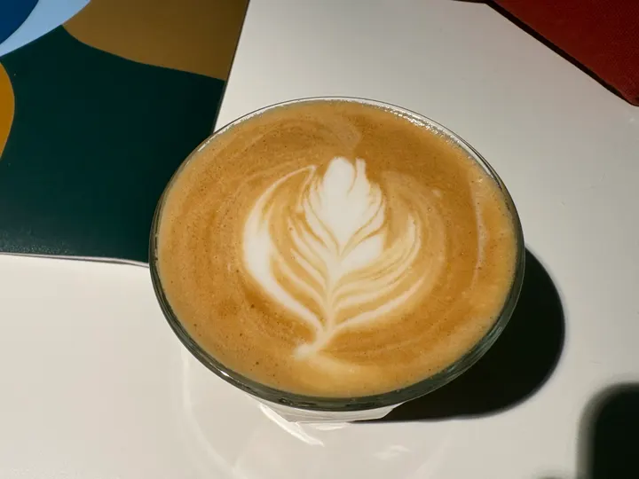 A latte with a tall, symmetrical rosetta